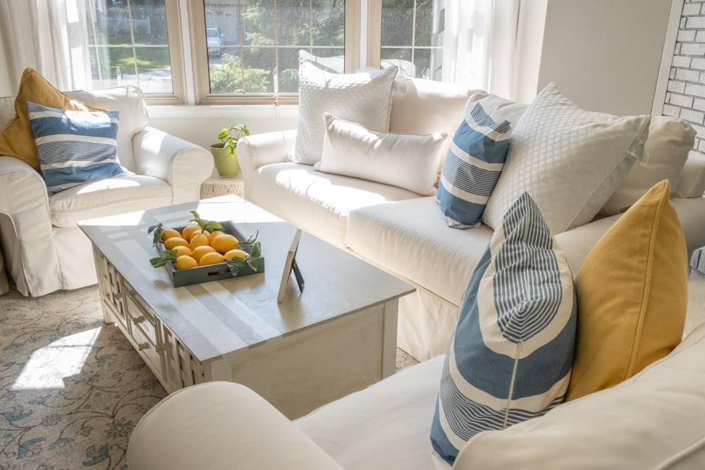 Living room with white sofa and fire place. Silhouette window treatments in the large windows near Danville, CA