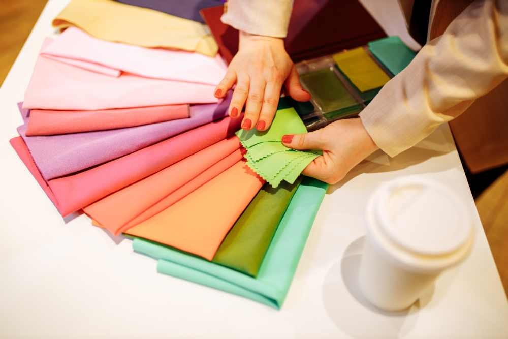 A person looking at fabric samples in a showroom