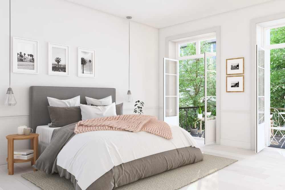 White painted bedroom with a large bed with a neutral bedspread near Danville, CA